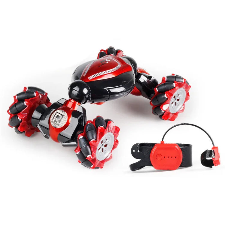 Red and black remote control stunt car with multi-directional wheels and wrist controller.
