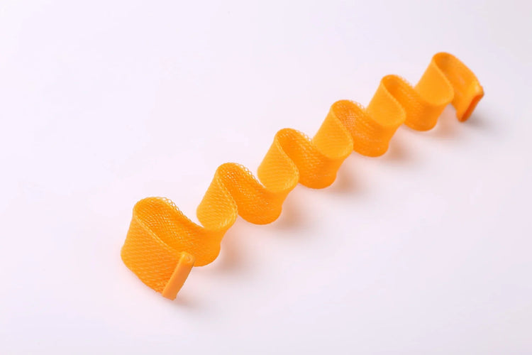 Bright orange mesh ribbon with a wavy, spiral shape, lightweight material on white background