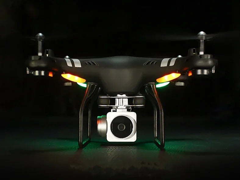 Black quadcopter drone with camera, LED lights, and sleek matte finish, front view