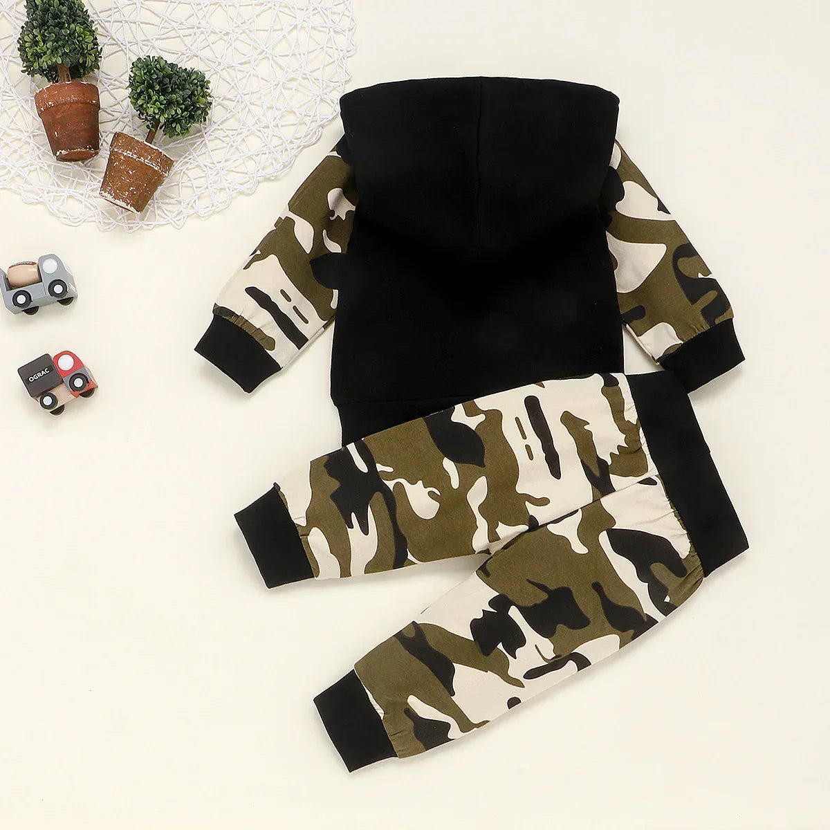 Kids' black hoodie with camouflage sleeves and matching camo jogger pants, relaxed fit