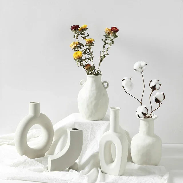 Minimalist white ceramic vases with matte finish, featuring dried flowers and cotton stems