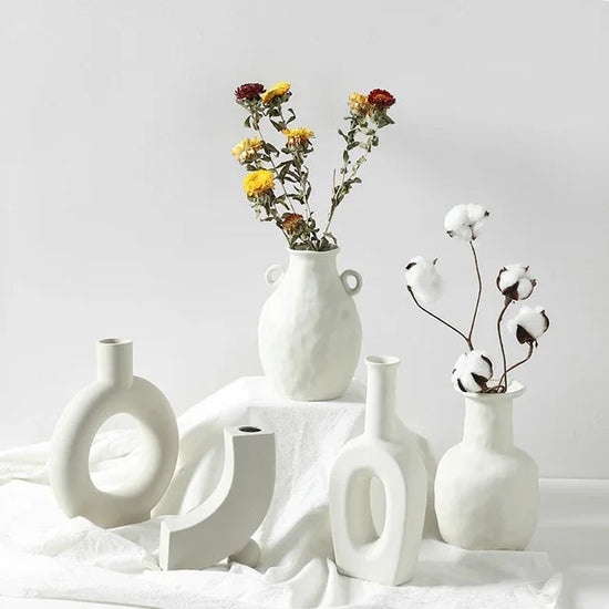 Minimalist white ceramic vases with matte finish, featuring dried flowers and cotton stems