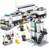 Block toy police station with mobile command truck, motorcycle, and three police figures.