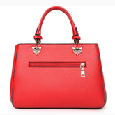 Red faux leather handbag with zipper pocket, gold hardware, and fox head details, structured fit