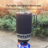 Black insulated portable camping stove pan with metal handle outdoors on stone surface