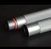 Close-up of two silver metal cylindrical rods with textured grip and threaded ends on black background.