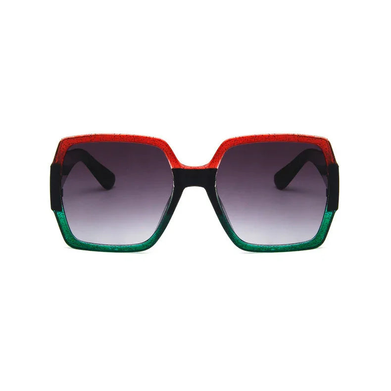 Oversized square sunglasses with red and green gradient frame, black arms, and tinted lenses