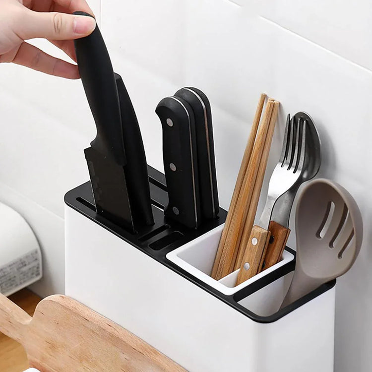 Modern kitchen utensil holder with black knives, wooden chopsticks, fork, and slotted spoon