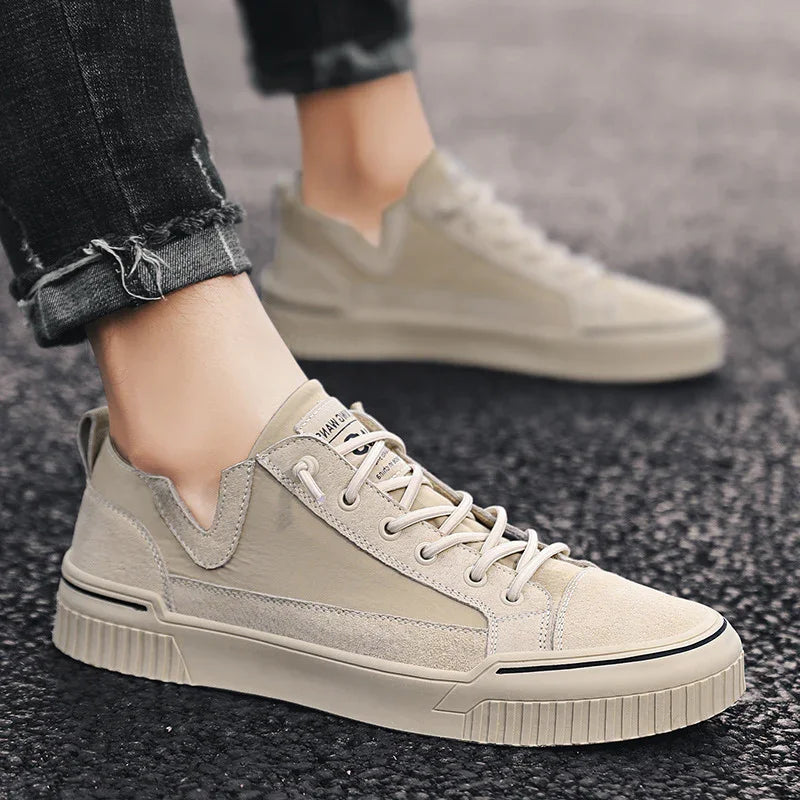 Beige low-top sneakers with suede and canvas panels, casual fit, worn with black jeans