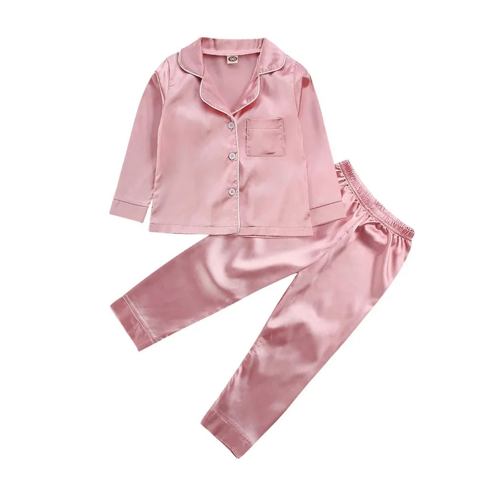 Pink satin long sleeve pajama set with button-up top and elastic waist pants, relaxed fit