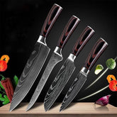 Set of four Damascus steel kitchen knives with wood handles on a cutting board, vegetables floating nearby.