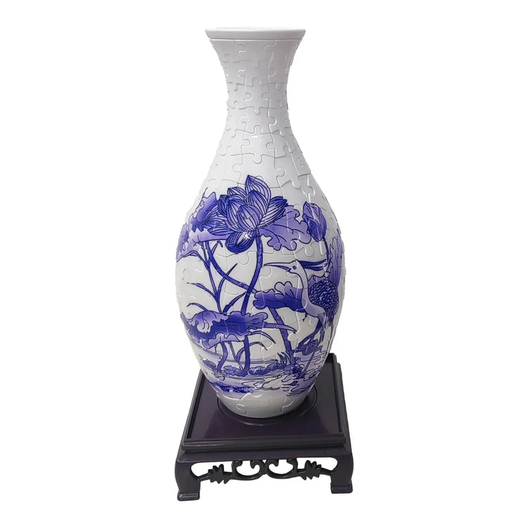 Blue and white ceramic vase puzzle with lotus and crane design on wooden stand