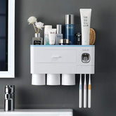 Modern white wall-mounted bathroom organizer with toothbrush holder and cups, sleek design