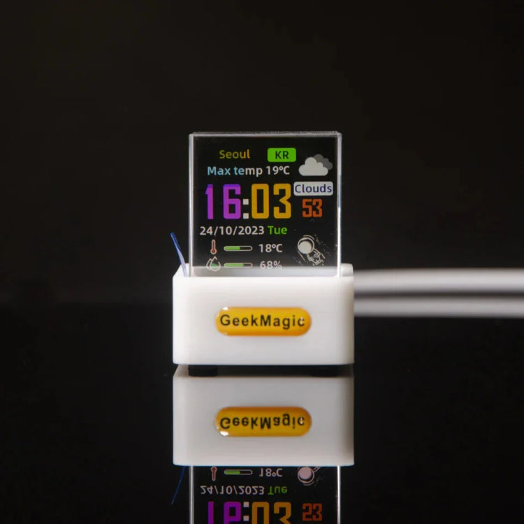 Mini transparent digital desk clock with colorful weather display, white plastic base, modern tech accessory