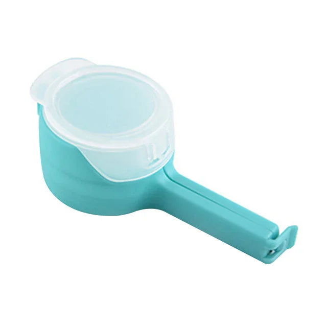 Turquoise plastic measuring cup with long handle and clear snap-on lid