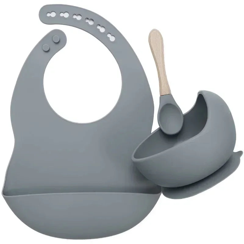 Gray silicone bib, bowl, and spoon set with modern, minimalist design.