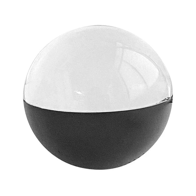Modern spherical decor ball, half black matte and half clear acrylic, minimalist style.