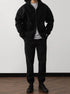 Man wearing black oversized zip hoodie and jogger pants, relaxed streetwear fit