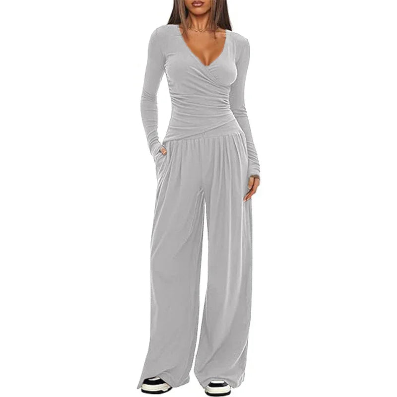 Woman wearing light gray long sleeve wrap top and wide leg pants lounge set