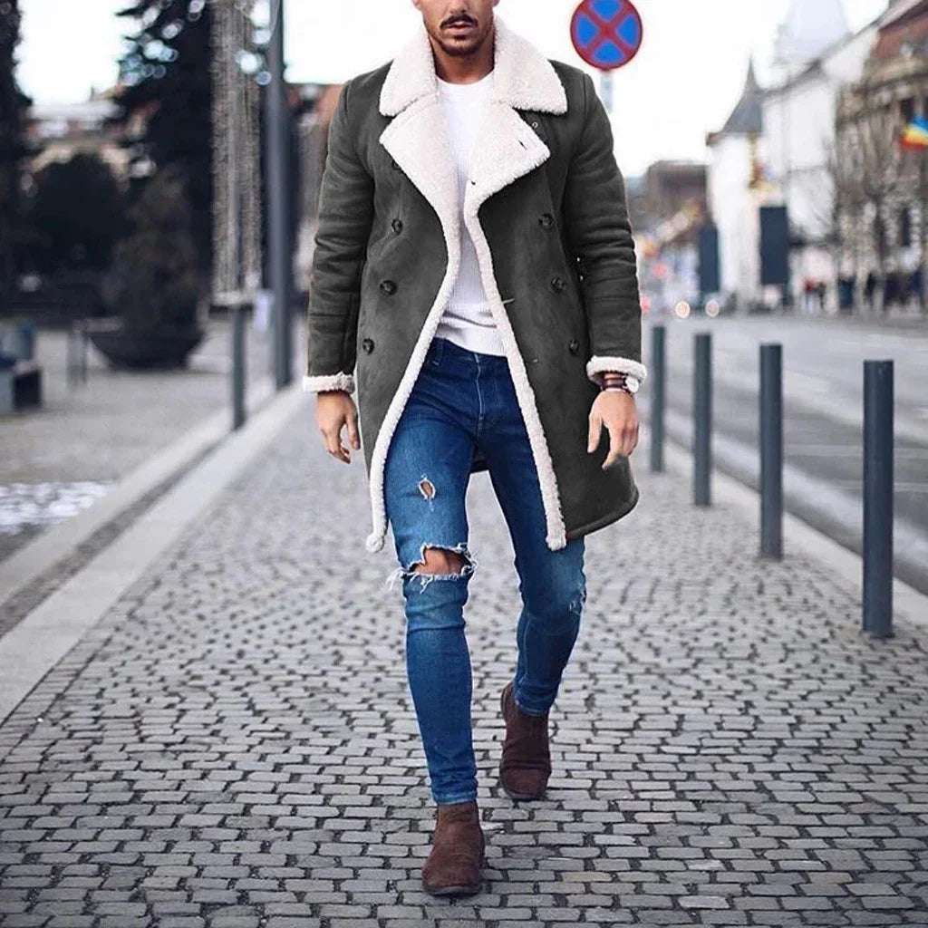 Man wearing dark shearling-lined trench coat, ripped skinny jeans, brown boots, street style
