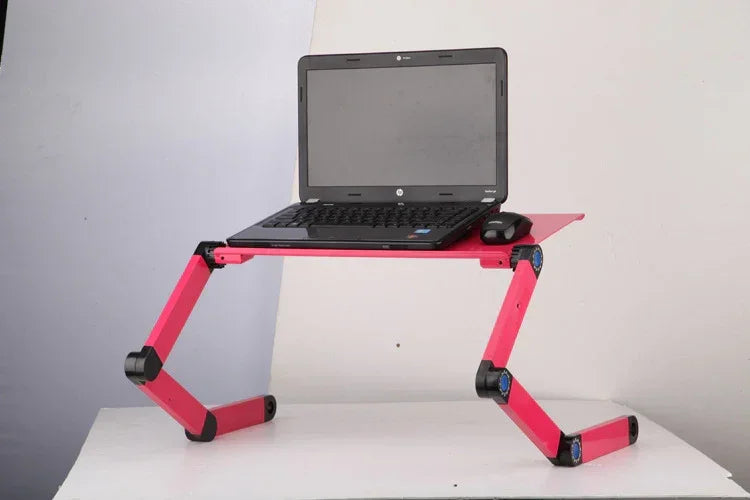 Adjustable pink aluminum laptop stand with flexible legs, supporting a black laptop and mouse