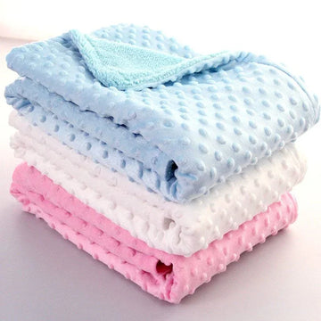 Stack of pastel blue, white, and pink textured fleece blankets, soft and plush material