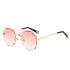 Round rimless sunglasses with wavy pink gradient lenses, gold metal arms, and black tips.