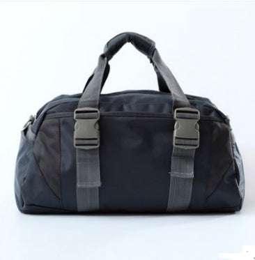 Black duffel bag with adjustable straps, durable nylon material, modern streetwear style