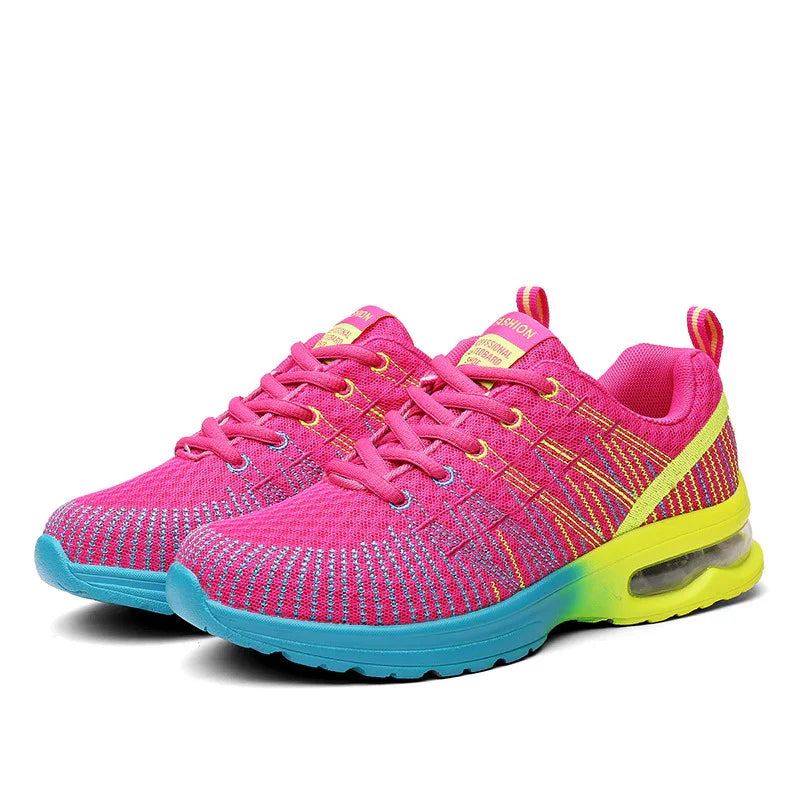 Pink mesh athletic sneakers with yellow accents and a blue gradient sole, lightweight fit