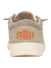Beige casual slip-on shoe with canvas upper, cushioned sole, and relaxed fit, rear view