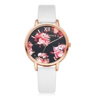 Rose gold floral watch with white leather strap, black dial, and pink flower design