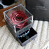 Deep red preserved rose in clear acrylic box with blue charm bracelet drawer on knit fabric