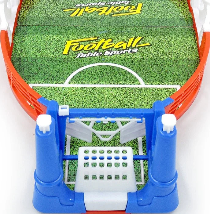 Mini tabletop football game with green field, blue and white plastic goal, and red trim