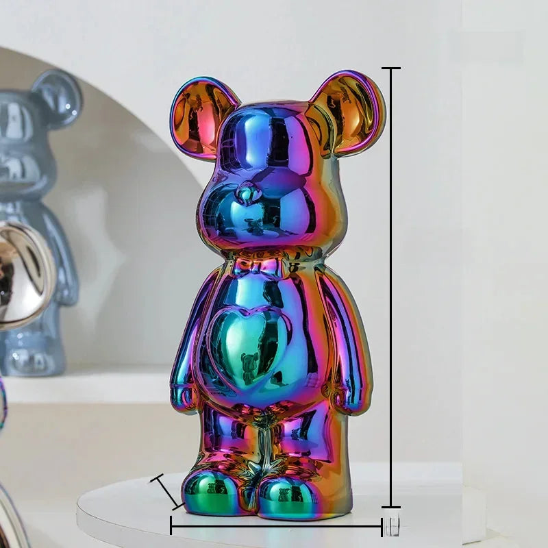 Metallic rainbow bear figurine with heart detailing, glossy finish, and modern decor style.
