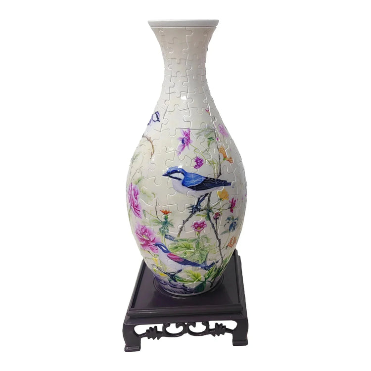 Floral vase jigsaw puzzle with colorful birds and flowers on a decorative wooden stand