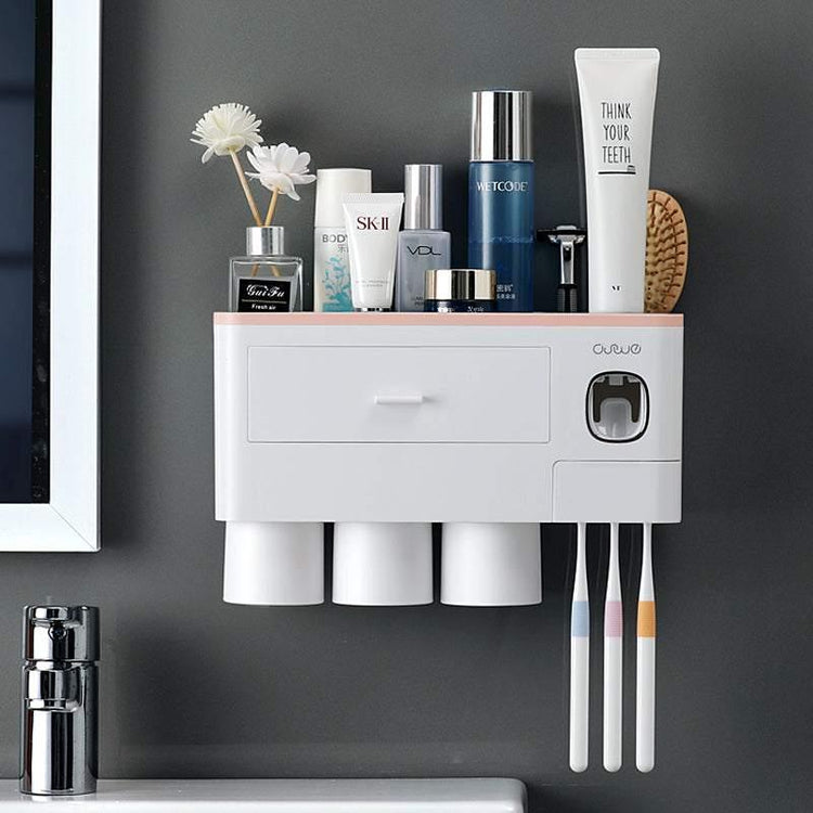 Wall-mounted bathroom organizer with toothbrushes, cups, and skincare products on a gray wall