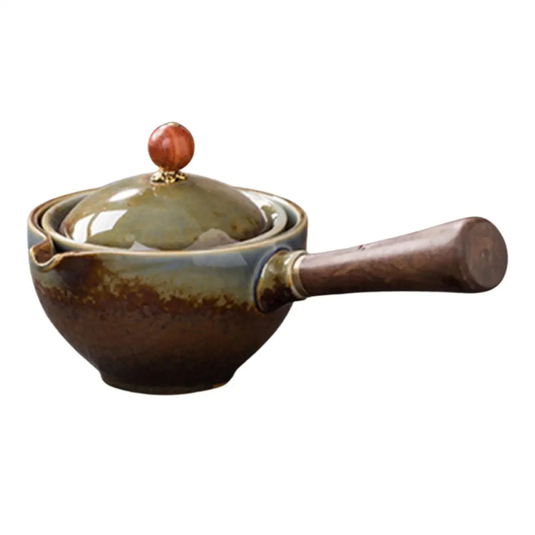 Ceramic teapot with wooden handle and glazed brown-green finish, matching lid, isolated on white