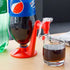 Red plastic drink dispenser stand for soda bottle with glass cup on wooden table