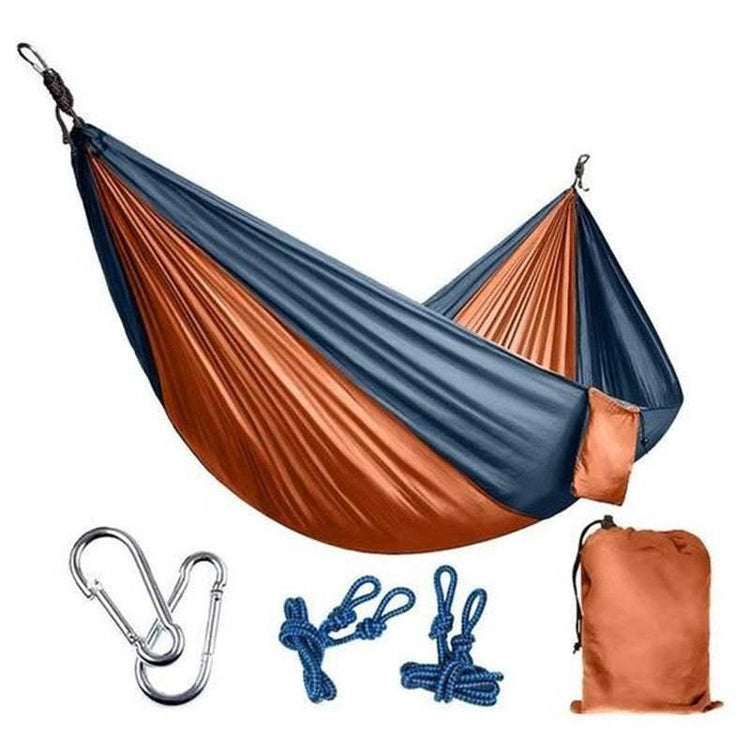 Two-tone blue and orange nylon hammock with carabiners, ropes, and matching carry bag.