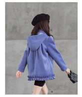 Girl wearing purple hooded coat with ruffle hem, relaxed fit, and black beret