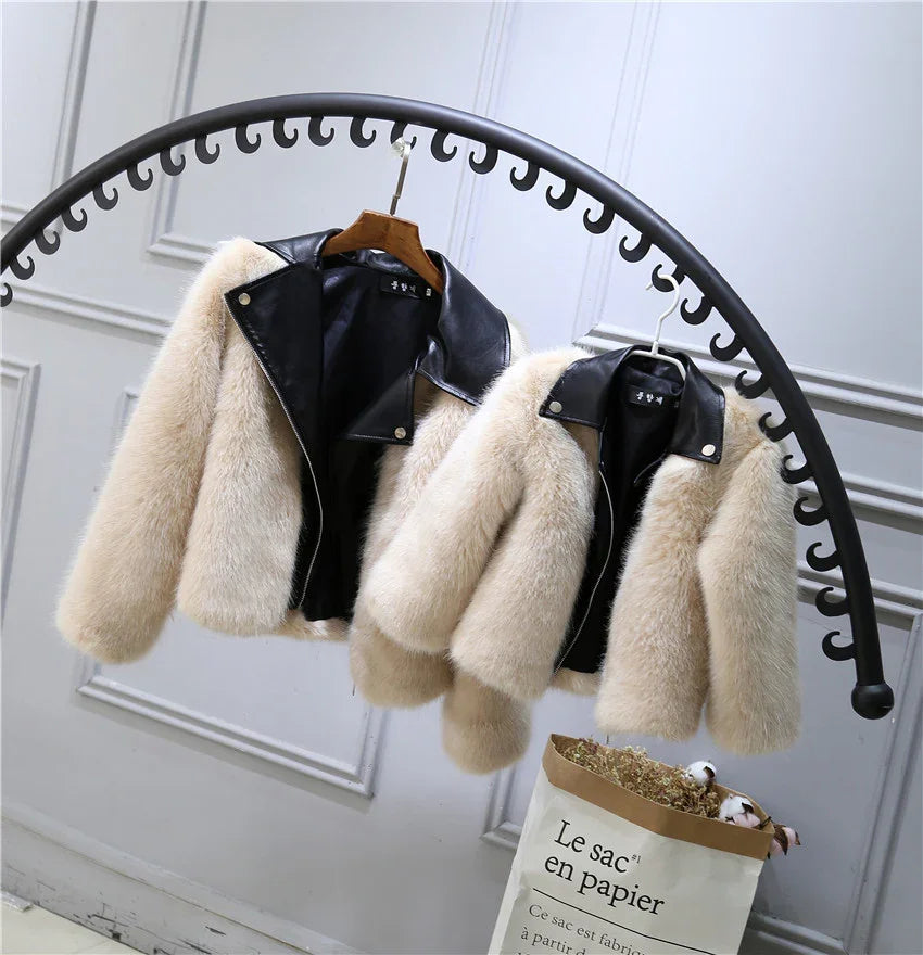 Beige faux fur jackets with black faux leather collars, cropped fit, hanging on rack