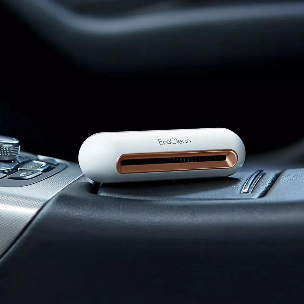 Compact white and copper car air purifier with sleek, rounded design on vehicle console