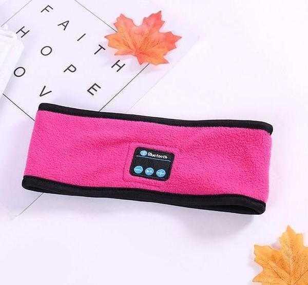 Pink fleece Bluetooth headband with black trim, tech accessory, flat lay on white background