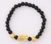 Black beaded bracelet with gold-toned decorative charms, minimalist streetwear accessory