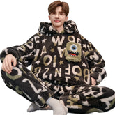 Man wearing oversized fuzzy loungewear set with black, white, and green letter print, cartoon patch, relaxed fit.