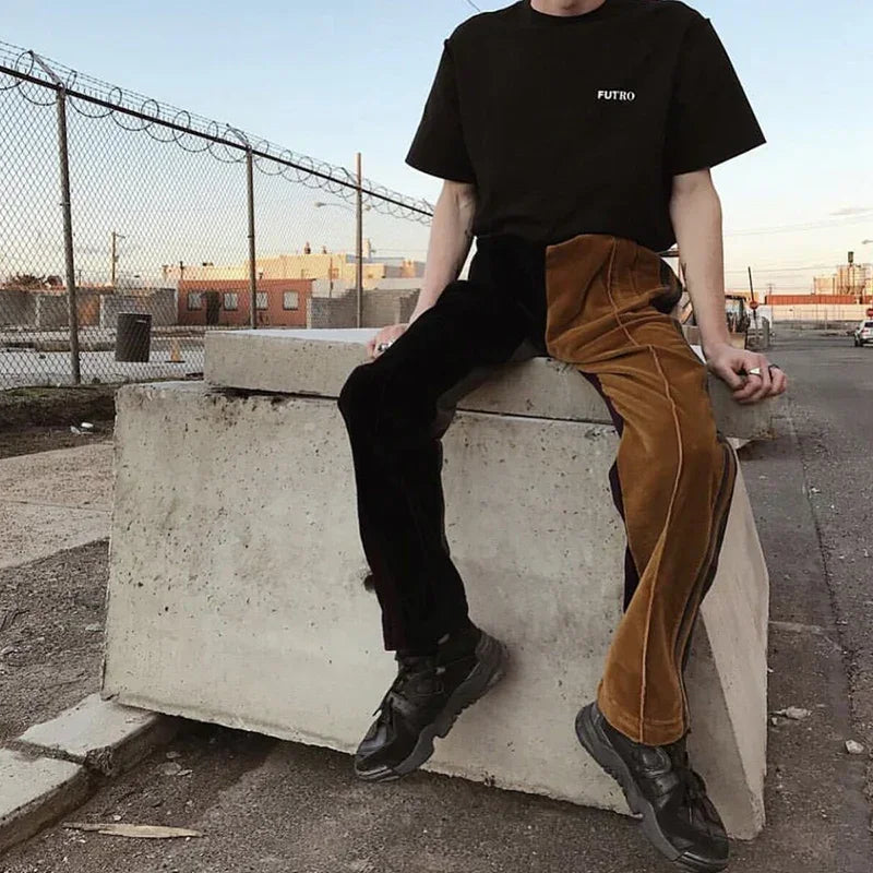 Man wearing black oversized t-shirt and colorblock velvet pants with relaxed fit street style