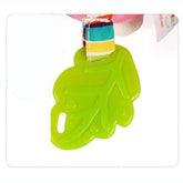 Bright green leaf-shaped silicone accessory with colorful fabric strap