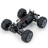 Black off-road RC car chassis with large rugged tires and exposed suspension system