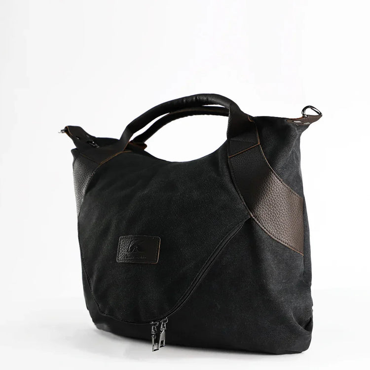 Black canvas and leather tote bag with zipper, modern streetwear accessory