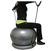 Woman in black fitted activewear sitting on silver exercise ball with resistance bands